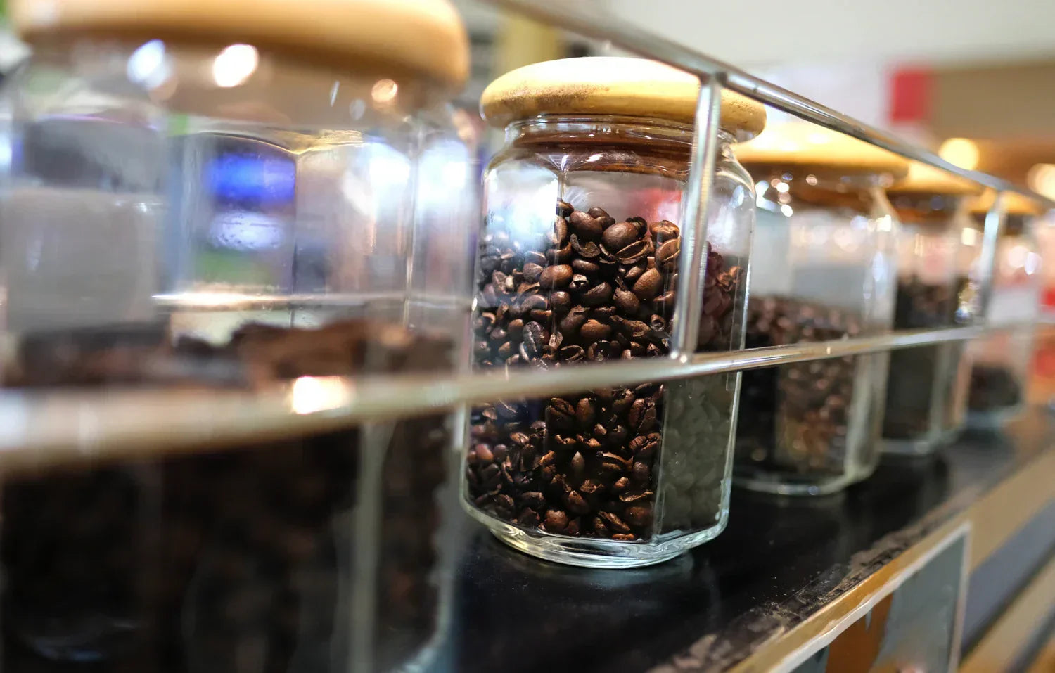An open shelf of cans full of fresh coffee beans