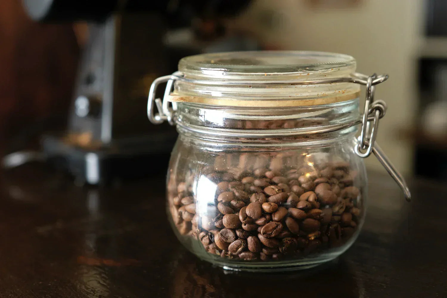 Freshly roasted coffee beans stored in an airtight container.